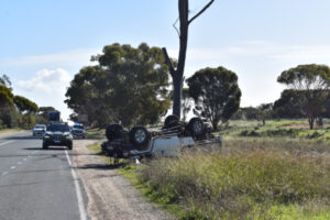 Car and boat roll near intersection
