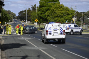 Highway blocked when car hits power pole