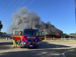 Woman charged over unit fire